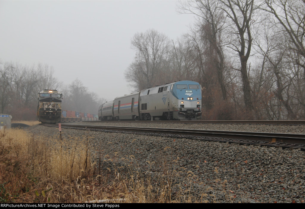 AMTK 87 heading east past MP 116 and NS 7717 on the siding